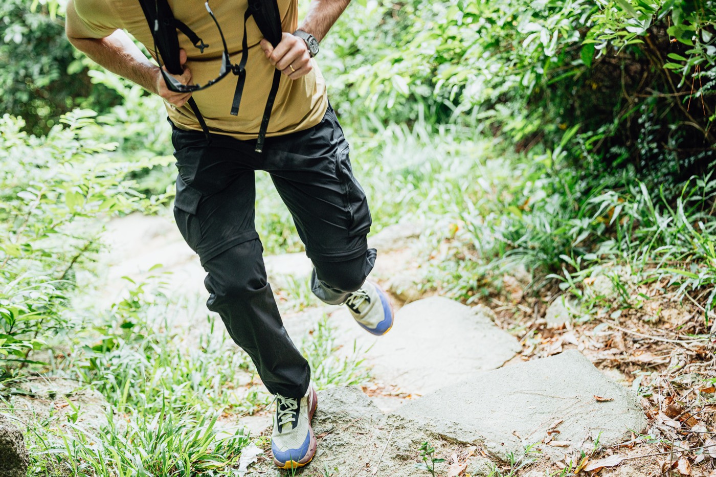 Striding across a rocky trail in All Rounder Adventure.